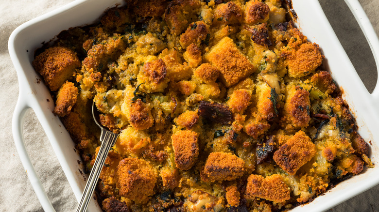 Oyster stuffing in a white baking dish placed on a white table