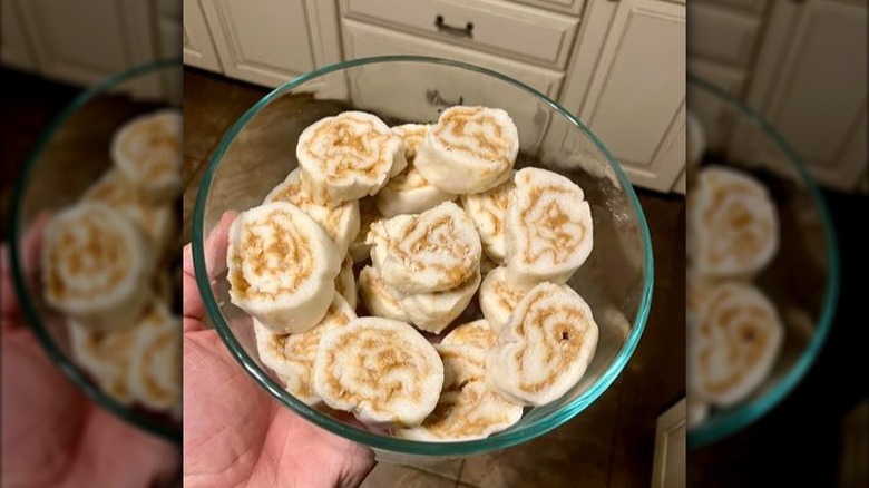 A person holding a bowl full of old-school potato candy