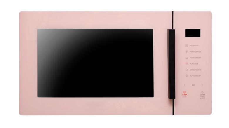 high-tech pink microwave on a white background