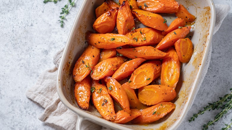 Glazed carrots in dish on marble table