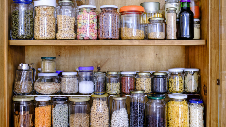Glass jars filled with various ingredients on shelf