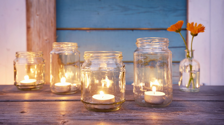 DIY jar candle lights with flowers in background