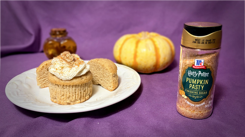 Jar of flavored sugar next to plate with cupcakes