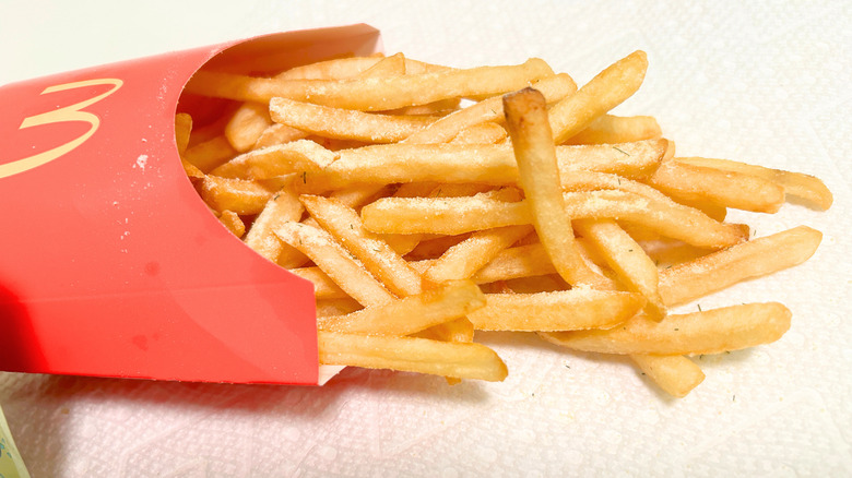 Close up of McDonalds fries covered in the new Grinch Salt seasoning