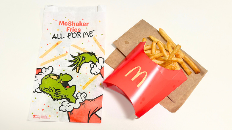 McDonalds fries next to a McShaker bag featuring the Grinch