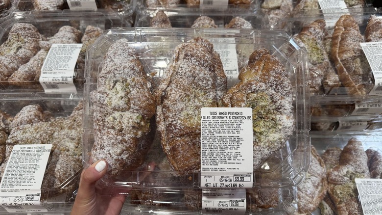 Costco pistachio croissant display in clear plastic boxes