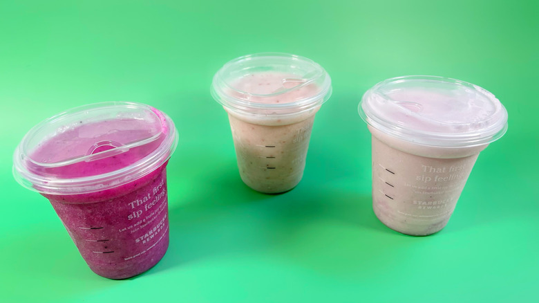 The three blended lemonade Refreshers on a green background