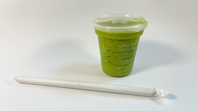 The blended matcha lemonade from Starbucks on a white background with a straw