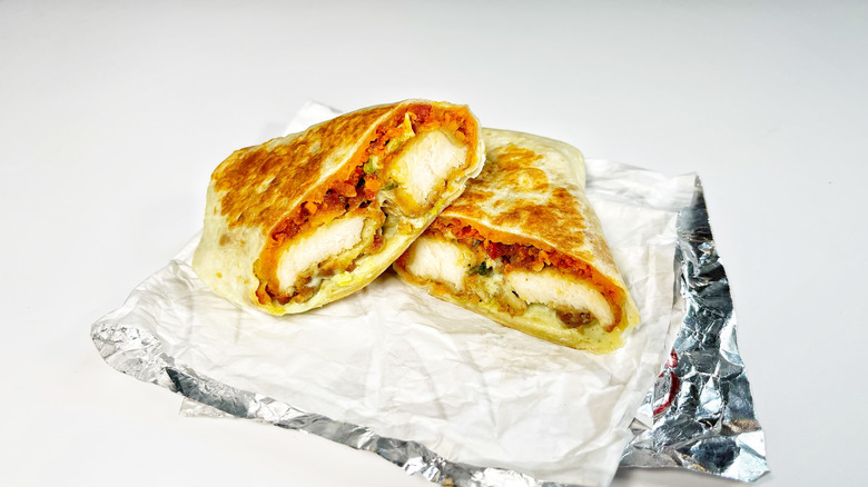 A closeup shot of Taco Bell's crispy chipotle burrito cut in half