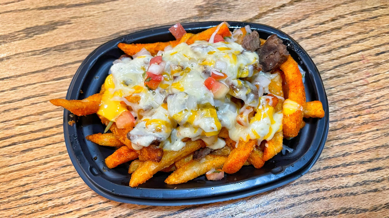 Taco Bell's pepper jack steak nacho fries on a wooden tabletop