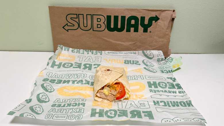 A Baja Chicken Protein Pocket on a wrapper in front of a Subway bag