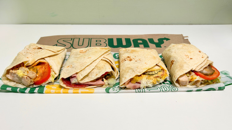 Four Subway protein pockets arranged in a line on a white surface