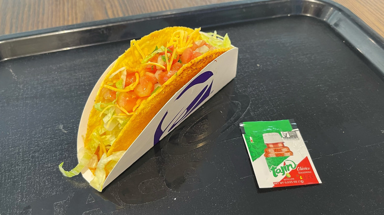 The Tajín Taco on a black tray with a Tajín packet
