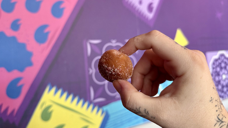 A hand holding a Strawberry Cinnamon Delight