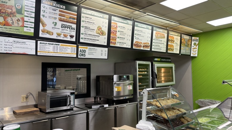 Subway menu above counter in a store