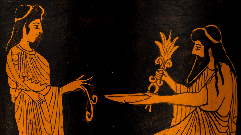 Ancient Greek urn depicting a man and a women exchanging foodstuffs