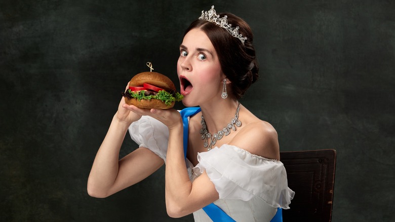 royal woman eating hamburger