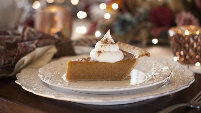 Sllice of pumpkin pie with whipped cream