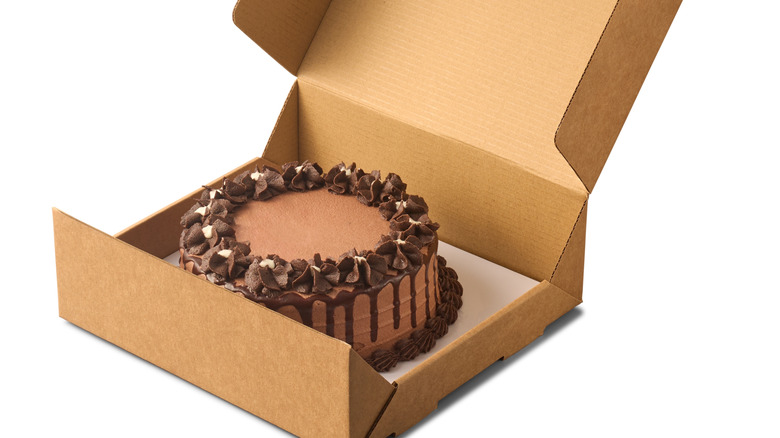 Chocolate cake in an open cardboard box