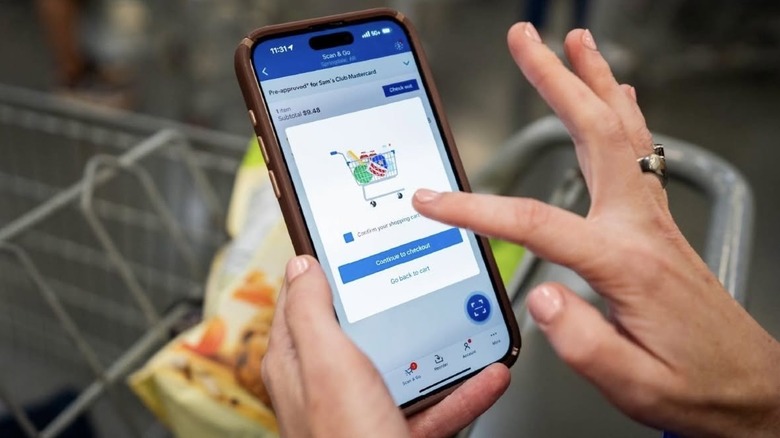 sam's club app with finger pointing at screen