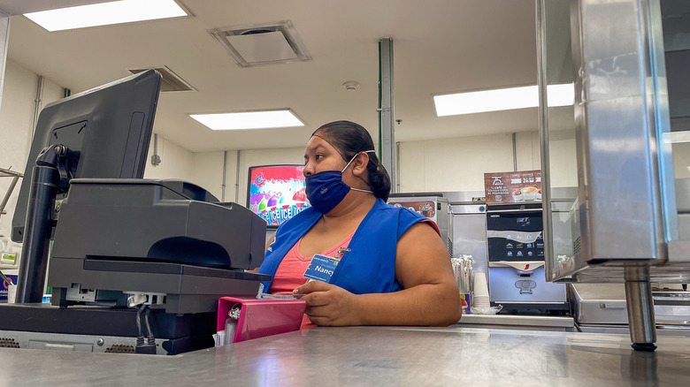 sam's club cashier at the cafe with face mask on