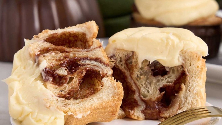 3 cinnamon rolls with iced frosting on top