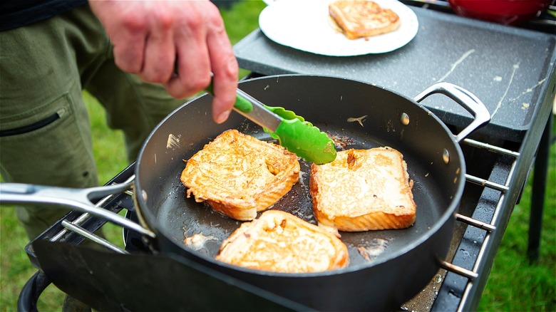 French toast cooking in pan outside 