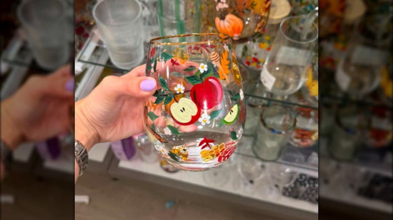 Painted stemless wine glass with apples on front