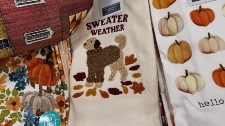 Tea towel with leaves, dog in sweater and "sweater weather"