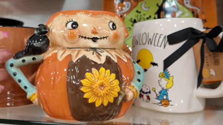 smiling scarecrow shaped mug with sunflower on front