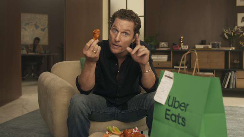 Matthew McConaughey holding a buffalo wing