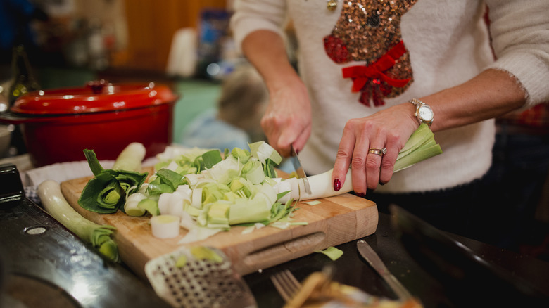 woman chopping leeks