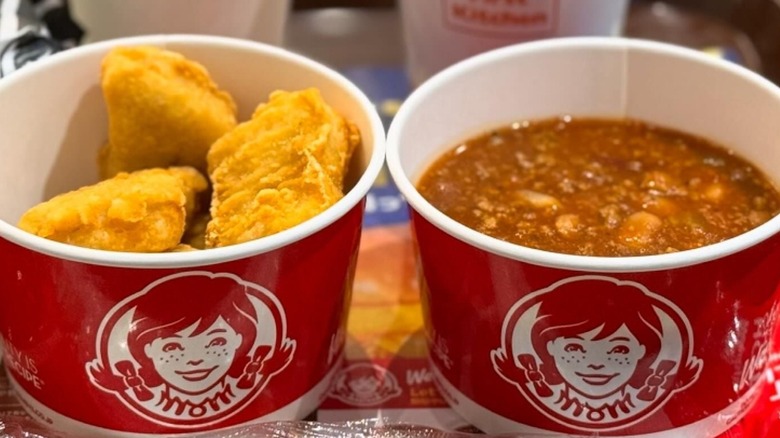 a cup of Wendy's chicken tenders next to a cup of Wendy's chili.