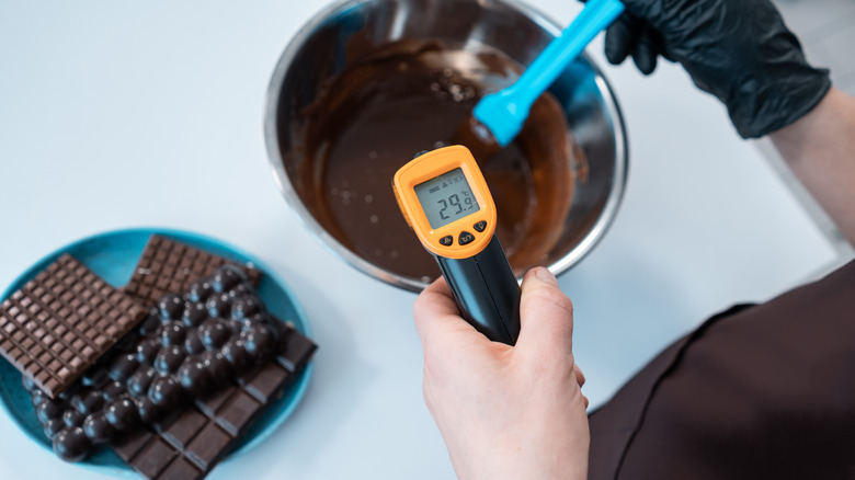 Thermometer measuring melted chocolate