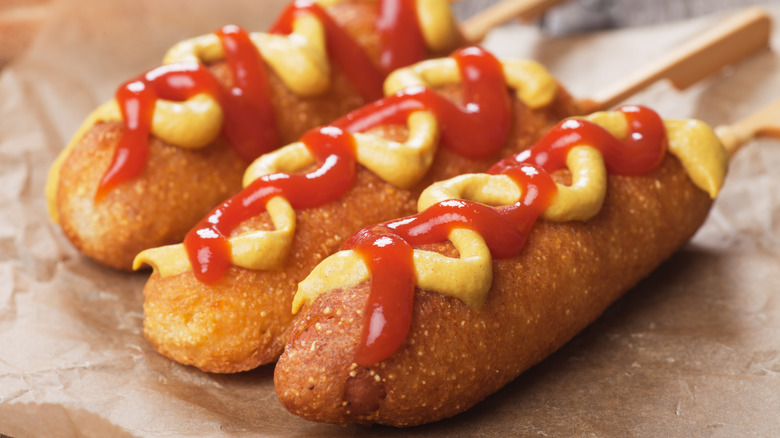 Corn dogs with mustard and ketchup
