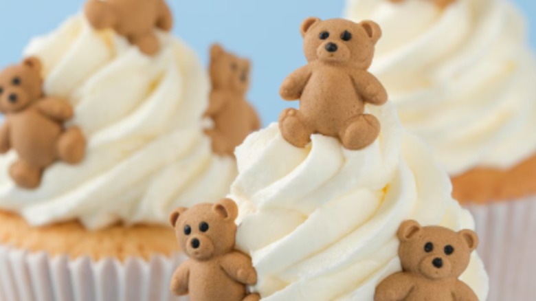 PME Cake Sweet Street icing decorations in the bear shape on top of vanilla cupcakes.