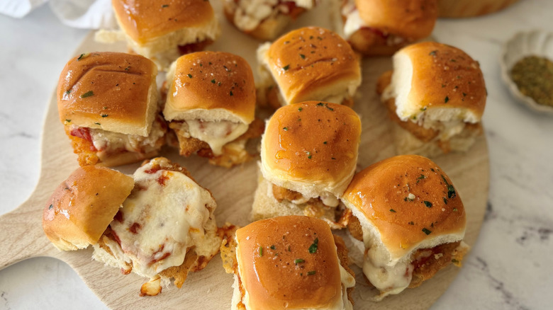 Chicken parmesan sliders served on wooden board