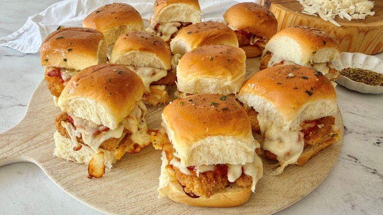 Chicken parmesan sliders served on wooden board