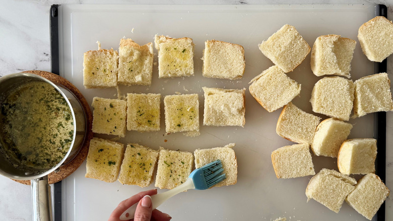 Brushing slider buns with garlic butter