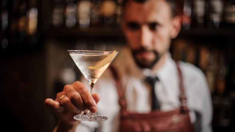 bartender holding chilled martini in glass