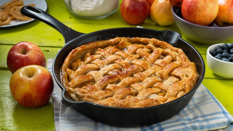 apple pie with lattice crust in a cast iron pan