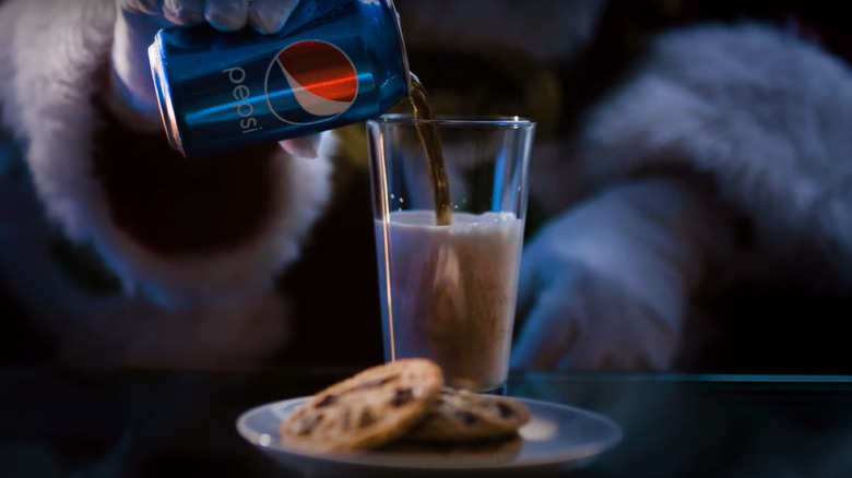 Santa pouring Pepsi into milk