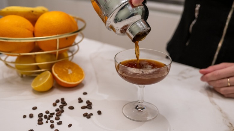 Close up of an espresso martini being made with fresh oranges