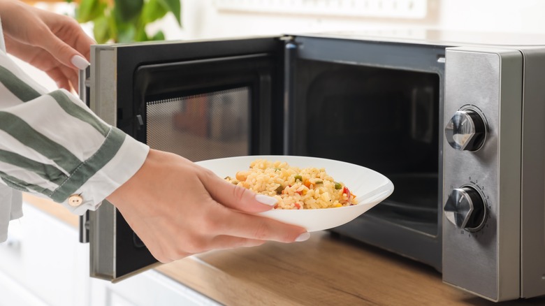 Bowl of rice going into microwave