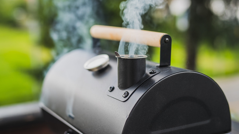 Smoker grill releasing smoke