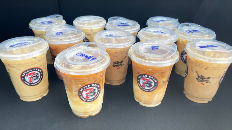 12 different 7 Brew coffee drinks lined up on a black background