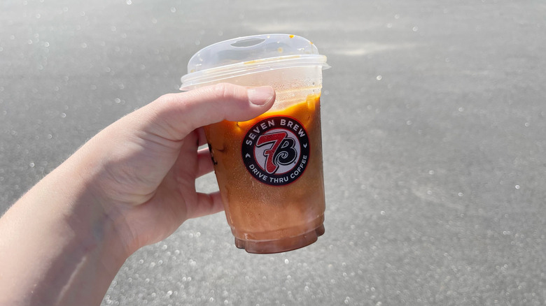 The layered Raspberry Truffle coffee held in a hand