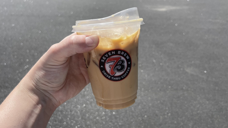 The Crème Brûlée latte held in a hand