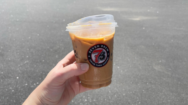 The Midnight Mint mocha held in a hand in a parking lot
