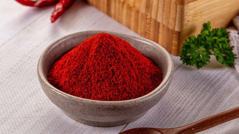 A gray stoneware bowl of red chili powder